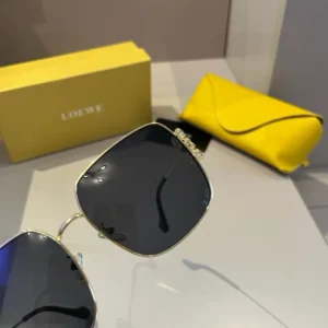 Loewe sunglasses gold frame black lenses with yellow leather case and branded packaging box