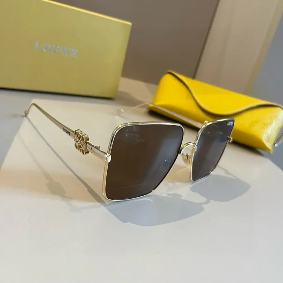 Loewe sunglasses gold metal frame black lenses with decorative temple detail and yellow leather case