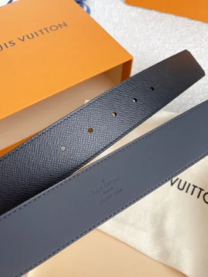 Louis Vuitton men's belt replica in black, showcasing double-sided calf leather design, presented with an orange box and cream dust bag, highlighting luxury accessory features.