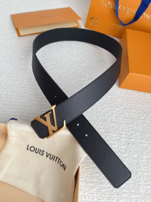 Louis Vuitton replica men's belt featuring a gold letter buckle, displayed on a soft fabric pouch with the brand's name, set against an orange packaging backdrop.