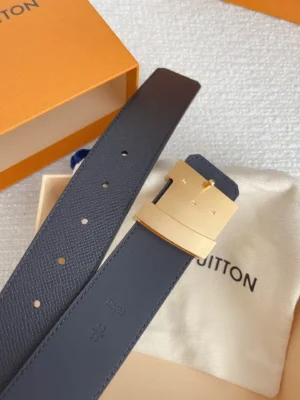 Louis Vuitton men's replica belt featuring a stainless steel buckle, displayed on a soft fabric with an orange box, emphasizing luxury accessory design and quality.