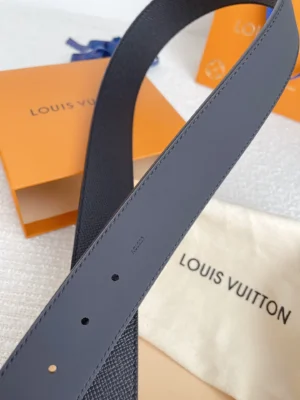 Louis Vuitton men's palm print belt displayed on a textured surface, featuring a gray leather design, with visible logo and packaging, emphasizing luxury and quality.