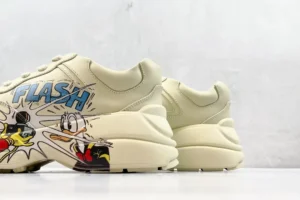 Gucci Rhyton Flash beige leather sneakers with Disney cartoon graphic and chunky sole