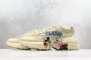 Gucci Rhyton Flash beige leather sneakers with cartoon graphic and blue logo detailing
