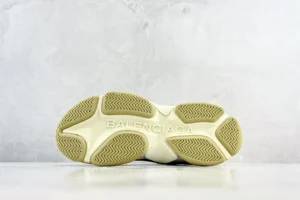 Balenciaga Track sneaker beige rubber sole shoe with embossed brand logo and textured outsole pattern