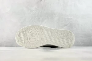 Gucci leather sneakers white rubber sole textured grip with interlocking G logo and Gucci branding