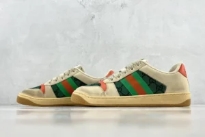 Gucci Screener Distressed Leather sneakers featuring green and red stripes, displayed against a neutral background, emphasizing luxury footwear design.