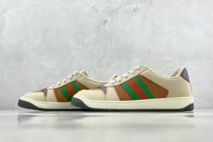 Gucci Screener distressed leather sneakers featuring green and red stripes, set against a neutral background, highlighting luxury footwear design.
