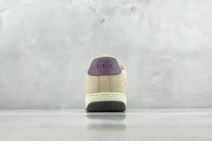 Gucci Screener distressed leather sneaker rear view featuring purple heel tab and textured black outsole.