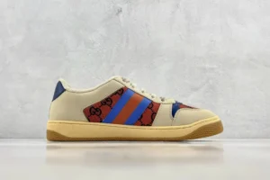 Gucci Screener Distressed Leather sneakers featuring a beige base with red and blue stripes and iconic logo detailing, displayed on a neutral background.