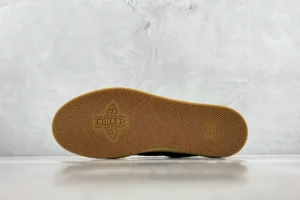 Gucci Screener Distressed Leather sneaker sole with textured gum rubber and embossed logo, showcasing the sneaker's quality and design features.