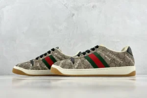 Gucci Screener Distressed Leather sneakers with signature GG logo pattern, red and green stripes, displayed against a neutral background.