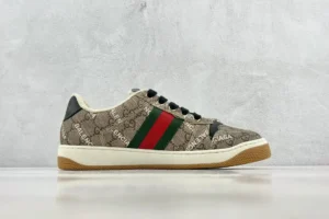 Gucci Screener Distressed Leather sneakers featuring the iconic GG pattern, green and red stripe, and a rubber sole, displayed on a neutral background.