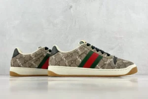 Gucci Screener Distressed Leather sneakers featuring iconic GG pattern and red-green stripe, showcased for e-commerce product listing.