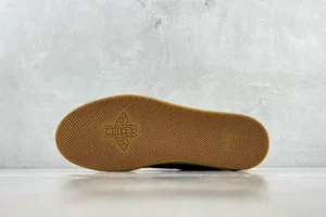 Gucci Screener distressed leather sneaker sole with textured gum rubber and logo detail, showcasing footwear design for online purchase.