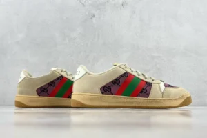 Gucci Screener distressed leather sneakers featuring beige upper with green and red stripes and logo detail, positioned against a neutral background.