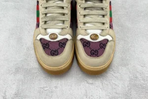 Gucci Screener distressed leather sneakers featuring iconic GG logo, beige and purple colorway, and green-red stripe detailing.