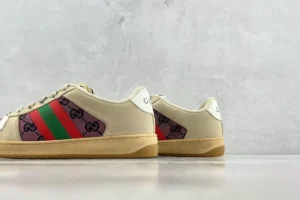 Gucci Screener distressed leather sneakers featuring iconic green and red stripes, displayed against a neutral background.