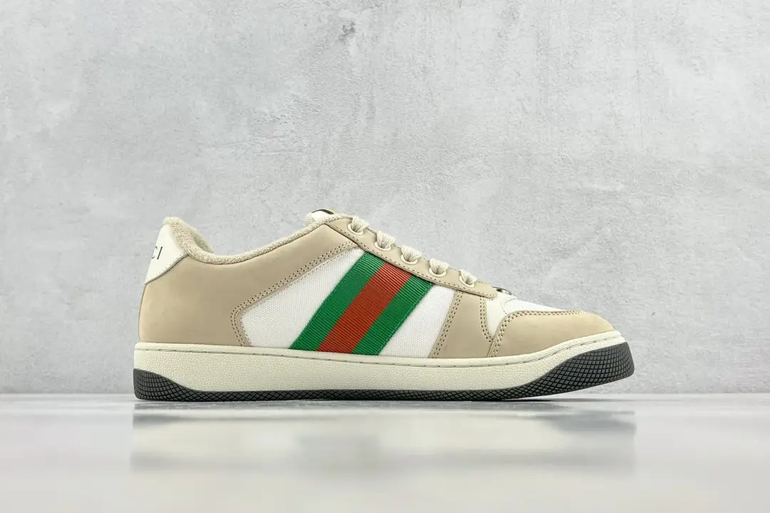 Gucci Screener Distressed Leather sneakers featuring beige and white design with green and red stripes, showcased on a light gray background.