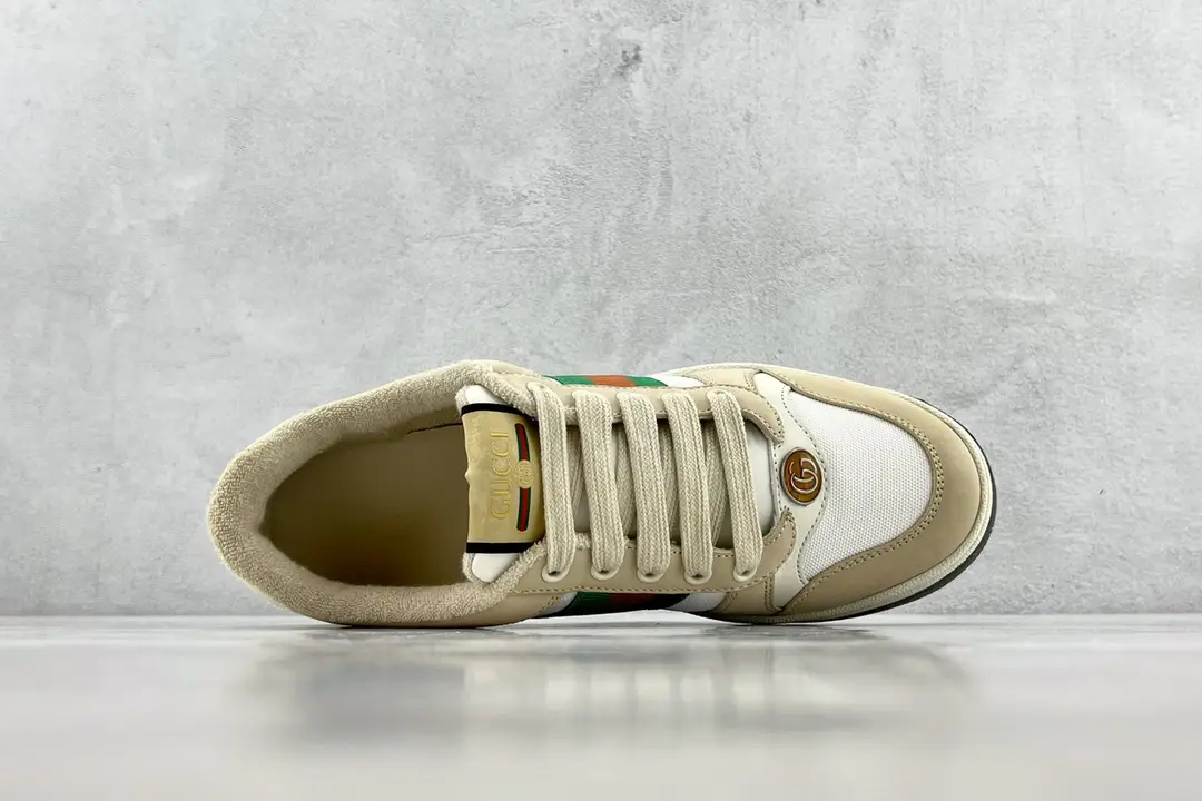 Gucci Screener Distressed Leather sneaker with beige and white color scheme, featuring logo and green-red stripe detail, displayed from above.