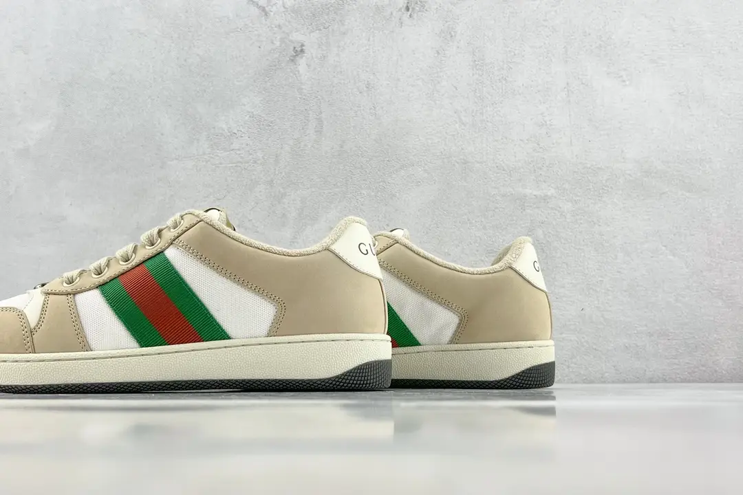 Gucci Screener Distressed Leather sneakers in beige with green and red stripes, showcasing the side and rear view against a neutral background.