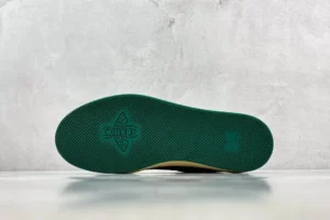 Green rubber outsole of Gucci Screener Distressed Leather sneaker, showcasing textured pattern and logo detail.
