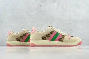 Gucci Screener Distressed Leather sneakers with pink and green stripes, showcasing luxury footwear design.