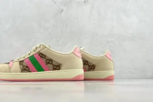 Gucci Screener Distressed Leather sneakers featuring a beige upper with pink and green stripes and signature logo detailing, showcased on a minimalist background.