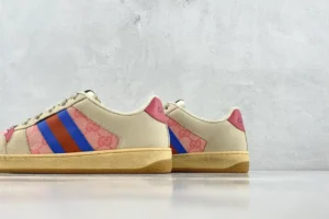 Gucci Screener Series GG Enamel used small dirty shoes with pink and blue stripes on a beige background, showcasing luxury replica footwear.