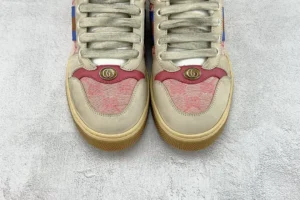 Gucci Screener Series GG Enamel used small dirty shoes, featuring a beige upper with red accents and logo detail, displayed on a textured surface.