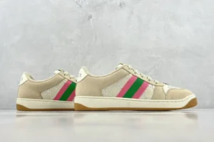Gucci Screener Series GG Enamel used sneakers featuring a beige upper with pink and green stripes, displayed against a neutral background.