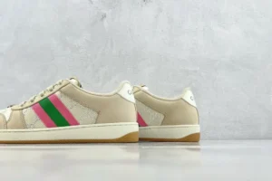 Gucci Screener Series GG Enamel used sneakers with pink and green stripes, displayed against a neutral background.