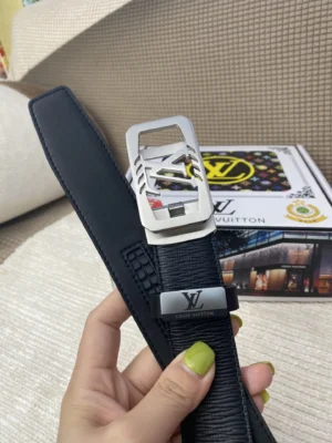 Luxury LV belt with 24K pure steel buckle, displayed in hand, featuring original cowhide leather and branded packaging.