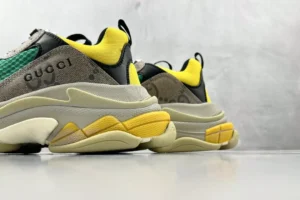 Gucci x Balenciaga Triple S sneakers showcasing a gray, yellow, and green color scheme, emphasizing luxury design and brand logos.