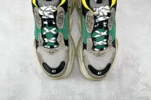 Gucci x Balenciaga Triple S Card sneakers in green, black, and yellow with visible size 41 and intricate detailing on the upper.