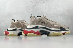 Gucci x Balenciaga Parisian Family Triple S Brown sneakers featuring a stylish design with signature logos and a multi-colored sole, displayed against a neutral background.