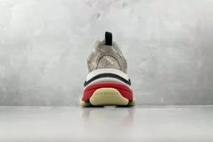 Gucci x Balenciaga Parisian Family Triple S Brown sneakers, rear view showcasing unique design elements and color accents against a neutral background.