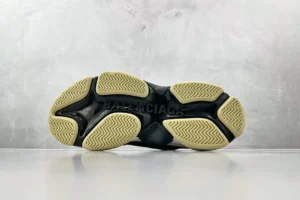 Sneaker sole of Gucci x Balenciaga Parisian Family Triple S Brown, showcasing detailed tread pattern and branding.