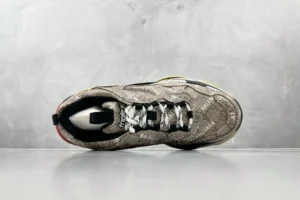 Gucci x Balenciaga Parisian Family Triple S Brown sneaker top view, featuring intricate pattern design and prominent lacing details on a neutral background.