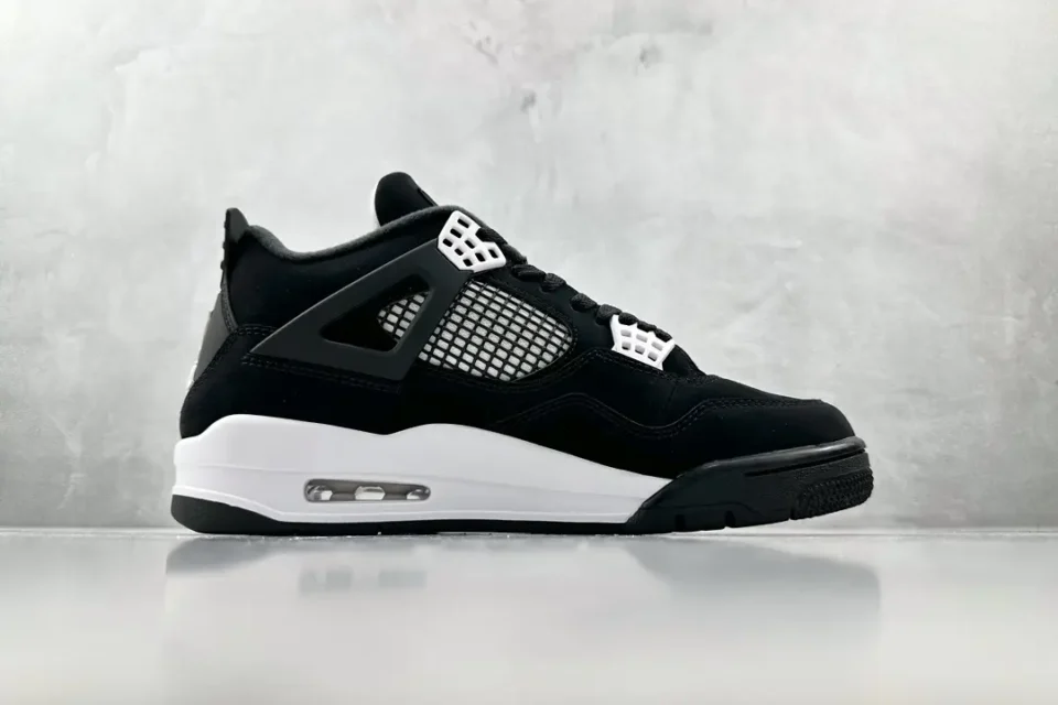 Nike Air Jordan 4 Retro black white mesh and suede sneakers with visible air cushioning sole