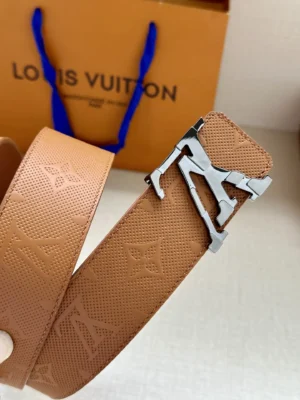 4.0-wide LV Shadow belt with Monogram featuring a double-layered LV buckle, displayed against a Louis Vuitton shopping bag.