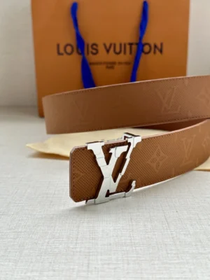 4.0-wide LV Shadow belt with Monogram featuring a silver LV buckle, displayed alongside a Louis Vuitton shopping bag, emphasizing luxury and designer fashion accessories.