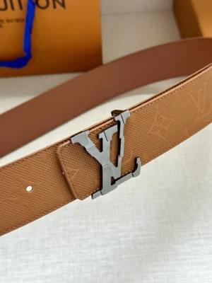 4.0-wide LV Shadow belt with Monogram featuring a silver LV buckle, set against a neutral background, highlighting luxury fashion accessories from Louis Vuitton.