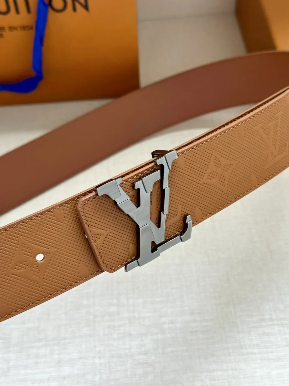 Louis Vuitton belt brown leather monogram embossed silver LV buckle luxury accessory