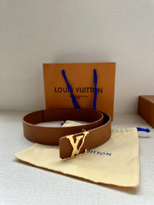 4.0-wide LV Shadow belt with Monogram displayed alongside Louis Vuitton packaging and dust bag, emphasizing luxury fashion accessory.