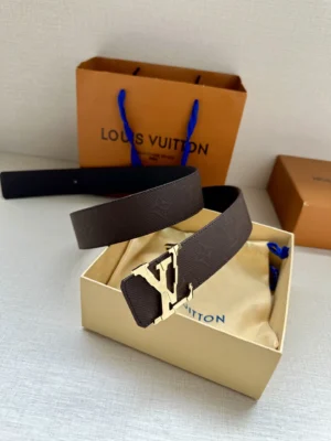 4.0-wide LV Shadow belt with Monogram in a gift box, featuring a gold LV buckle, alongside a Louis Vuitton shopping bag.