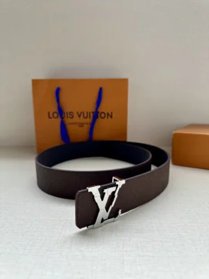 4.0-wide LV Shadow belt with Monogram displayed next to Louis Vuitton packaging, featuring a silver LV buckle and dark leather strap.