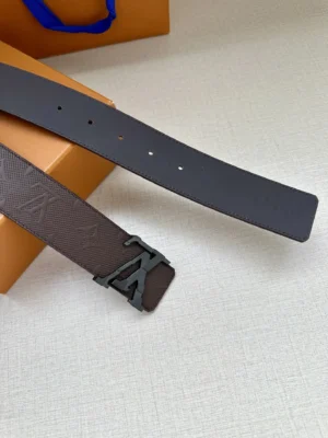 4.0-wide LV Shadow belt with Monogram featuring a double-layered LV buckle, displayed on a neutral background with an orange box.