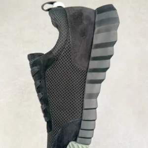 Hermes Men’s Bouncing Sneaker in technical mesh, showcasing a black upper, textured outsole, and modern design, highlighting luxury footwear for casual wear.