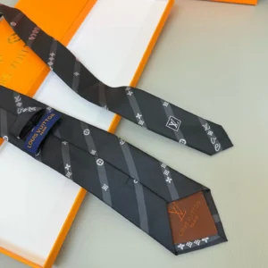 Silk LV tie featuring diagonal stripes, LVVers logo, and Monogram flowers, displayed on a surface with an orange box, emphasizing luxury and versatility for formal or casual wear.